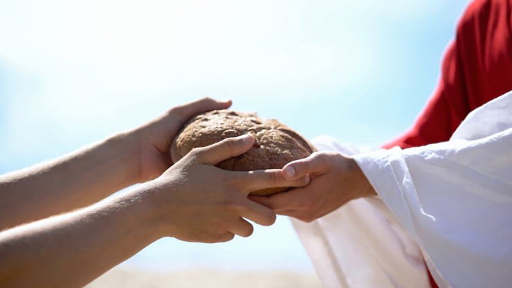 Jesus hands giving bread to poor man, biblical story to feed hungry, charity