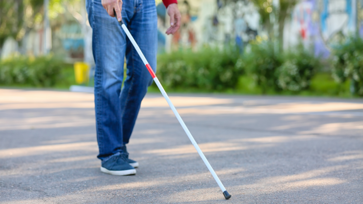 Blind senior man walking outdoors