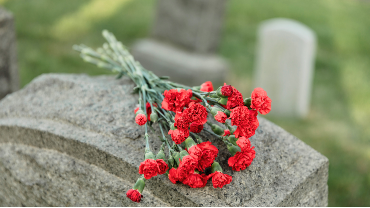 red flowers on a tombstone